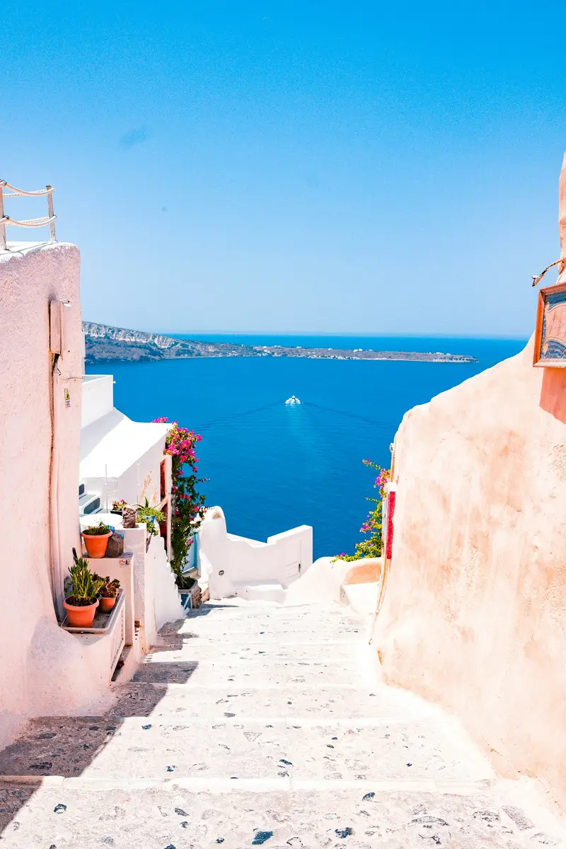 A sunlit Mediterranean passage opening toward the sea